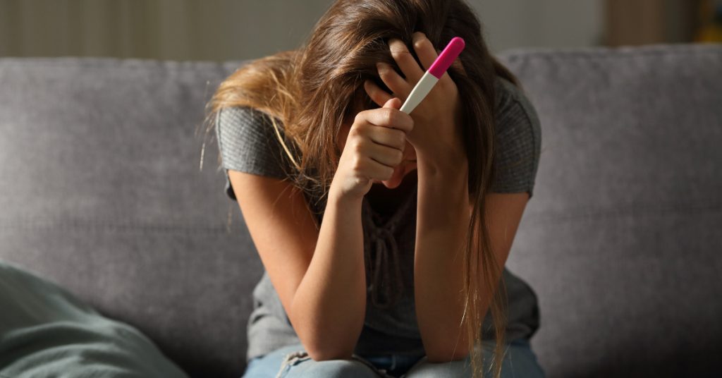 woman holding pregnancy test